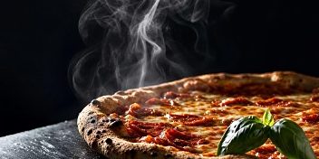 Steaming pizza on a dark surface